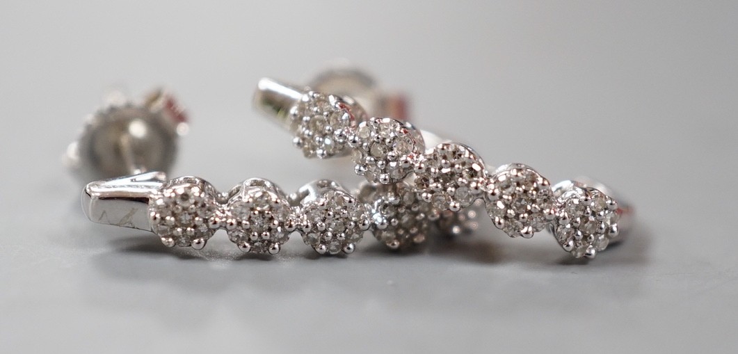 A modern pair of 375 white metal and diamond quintuple cluster set demi-lune earrings, 16mm, gross weight 1.7 grams.